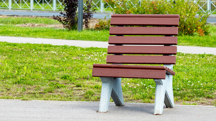brown wooden bench for introverts in a public Park