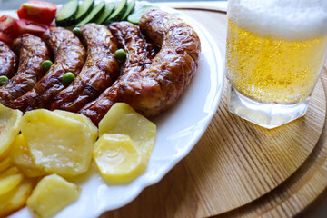 grilled sausages with vegetables on a white plate