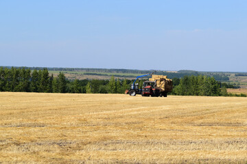 Fototapeta premium machines remove hay from the fields