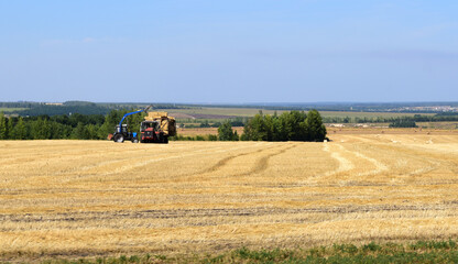Obraz premium machines remove hay from the fields