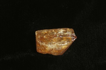 IMPERIAL TOPAZ STONE AGAINST BLACK BACKGROUND