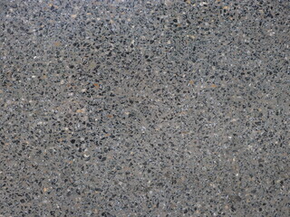 Gray polished concrete interspersed with fine stone