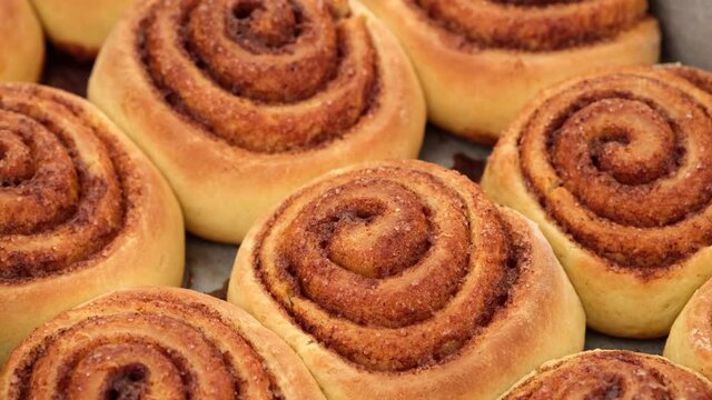 Freshly baked cinnamon rolls or Cinnabon close up rotating