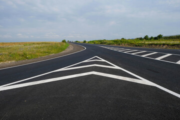 New road. Road markings. Fresh paint. Copy space.
