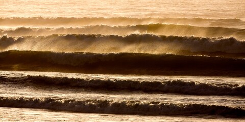 WAVES IN ATLANTIC OCEAN AT SUNSET, CAPE CROSS IN NAMIBIA