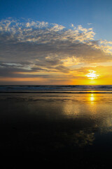 Fototapeta na wymiar Sunset at beautiful beach at Canoa, pacific coast, Puerto Lopez, Manatí, Ecuador (vertical)