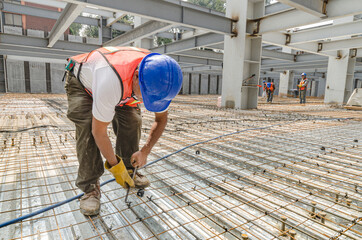 Construction worker tightening the iron mesh rods to steel plates
Galvanized steel flooring in a...