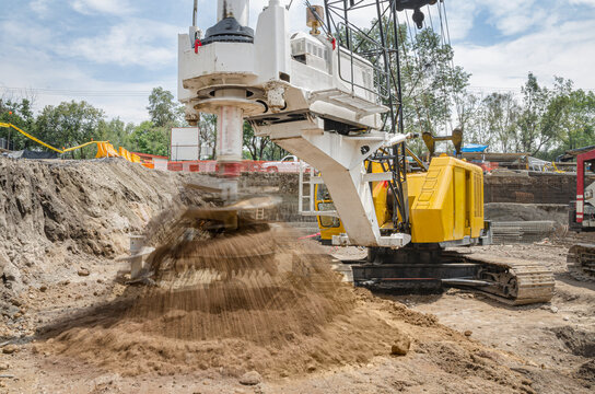 Drilling tractor vehicle in construction site
Driller removing earth with its huge auger so can steel columns can be set as structure foundations
