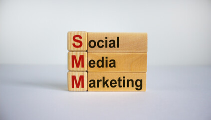 Concept words 'SMM, social media marketing' on cubes and blocks on a beautiful white background. Business concept. Copy space.