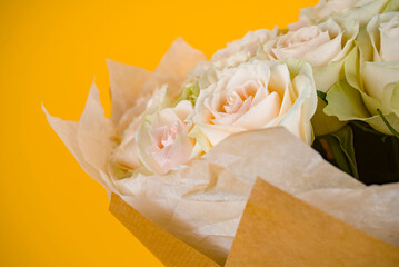 White roses bouquet on the yellow background