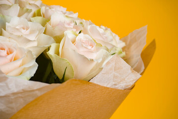 White roses bouquet on the yellow background