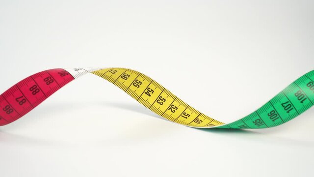 Twisted bright multi-colored centimeter measuring tape on a white background. Close-up. Diet and Measurement Tool