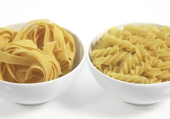 Tagliatelle and Twisted Pasta Against White Background