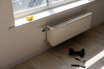 Close-up of mature mechanic hands repairing heating system.