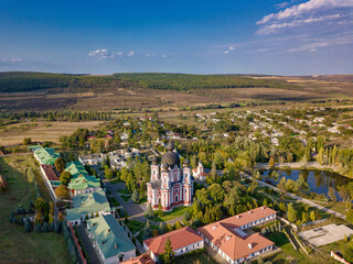 Flight over a christian monastery surrounded by autumn forest. Kurky monastery, Moldova republic of. © Igor Syrbu