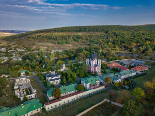 Fototapeta na wymiar Flight over a christian monastery surrounded by autumn forest. Kurky monastery, Moldova republic of.
