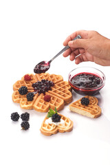Girl served waffles with blueberry jam, Breakfast with coffee. White background, top view, close up