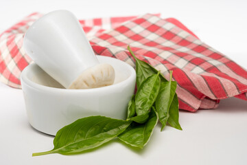 Mortar and Pestle with fresh Basil leaves