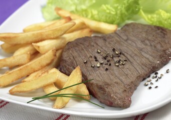 Steak with French Fries and Salad on Plate