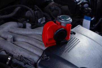 Red air horn for a car on a car engine. Electric Car air horn