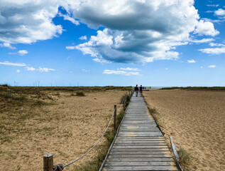Fototapeta premium Great Yarmouth beach in a summer day, traditional UK English East Coast landscape, blue and brown, sky with clouds no people, large stretch of sand, UK beaches