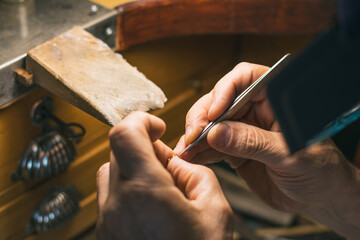 Hands of a craftsman jeweler working on jewelry. Goldsmith.
Goldsmith workshop jewels and articles of work value