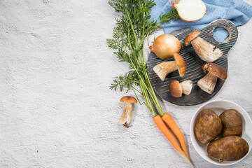 Ingredients for cooking various dishes from forest porcini mushrooms. Horizontal arrangement. Place for copy space