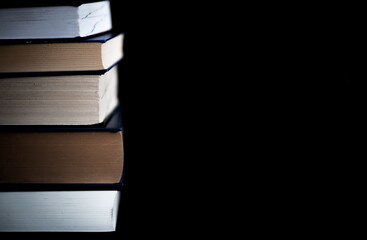 A stack of books on a black background