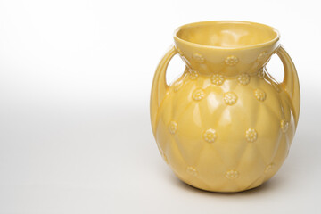 Antique yellow ceramic vase isolated on a white background