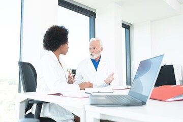 Male and female doctors discussing at office