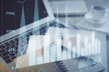 Double exposure of financial chart drawing and desktop with coffee and items on table background. Concept of forex market trading