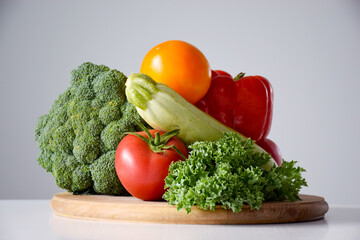 Assortment of organic vegetables: broccoli, tomato, zucchini, pepper and kale salad. Healthy eating or dieting concept.