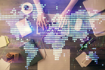 Double exposure of woman hands working on computer and financial theme hologram drawing. Top View. Business concept.