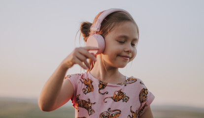Close up portrait of a young girl with pink headphones listening to music and dancing to the vibe, concept summer, album cover, spotify 