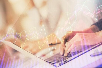 Double exposure of woman hands typing on computer and forex chart hologram drawing. Stock market invest concept.