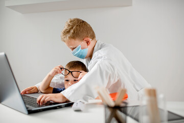 Fototapeta premium Two boys are playing doctor,
