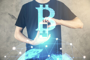 Double exposure of man's hands holding and using a phone and crypto currency blockchain theme drawing.