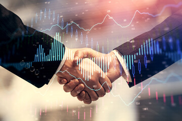 Double exposure of forex graph hologram and handshake of two men. Stock market concept.