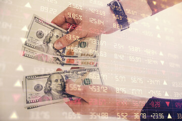 Fototapeta premium Multi exposure of financial graph drawing hologram and USA dollars bills and man hands. Analysis concept.