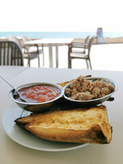 Breakfast at Mediterranean bread with tuna and grated tomato