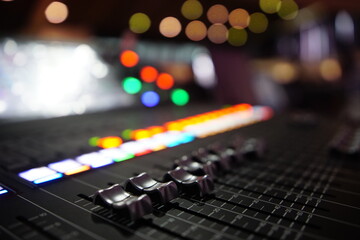 Fototapeta na wymiar Black audio sound mixer with sliders button. Bokeh background