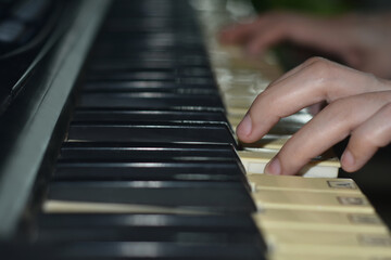 Fingers playing piano on the keys