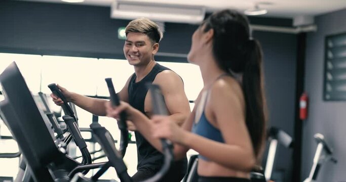 Two asian with elliptical cardio exercising active healthy lifestyle.