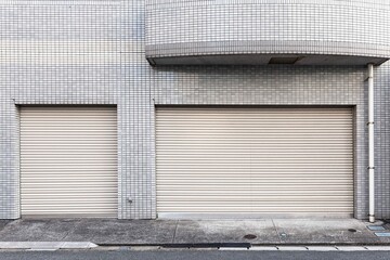 Automatic silver roller shutter doors on the ground floor of the house