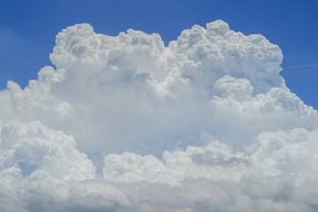 Naklejka na ściany i meble Blue sky background with white dramatic clouds.