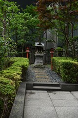 The little shrine at the corner of the office buildings in Tokyo Japan