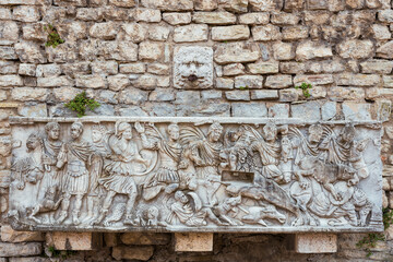 Old fountain with ancient roman reliefs in Spoleto Cathedral Square