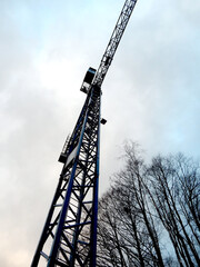 crane against the sky, construction of a multi-storey house