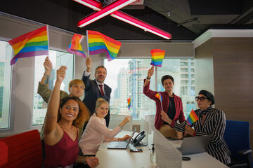 diverse business people with LGBTQ have rainbow flag on hand