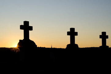 Triple Crosses Silhouettes against the Golden Sunset